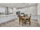 Bright, white kitchen with stainless steel appliances, a large island, and a breakfast nook at 5851 Slate Rock Ct, Las Vegas, NV 89149