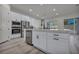 Kitchen island with stainless steel appliances, white cabinetry, and ample counter space at 5851 Slate Rock Ct, Las Vegas, NV 89149