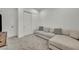 Living room features a plush sectional sofa, carpet, and natural light from the windows at 5851 Slate Rock Ct, Las Vegas, NV 89149