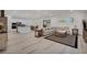 Bright, open-concept living room with hardwood floors connecting to a kitchen and dining area at 5851 Slate Rock Ct, Las Vegas, NV 89149