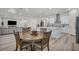 Open-concept living space featuring a kitchen, dining area, and living room with bright, natural light at 5851 Slate Rock Ct, Las Vegas, NV 89149