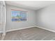 Bedroom with neutral carpet, a window with blinds, and base trim at 5861 Medallion Dr # 202, Las Vegas, NV 89122