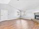 Open-concept living room with wood-look flooring and cozy fireplace at 5861 Medallion Dr # 202, Las Vegas, NV 89122