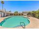 Community pool with lounge chairs, well maintained landscaping, and shaded pergola area at 5861 Medallion Dr # 202, Las Vegas, NV 89122