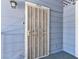 Exterior view of a secure front door with decorative security gate and exterior light fixture at 5861 Medallion Dr # 202, Las Vegas, NV 89122