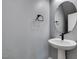 Modern powder room with a round mirror and sleek faucet at 649 Tranquil Jade St, Las Vegas, NV 89138