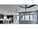Open-concept living room with large windows provides ample natural light into the modern kitchen with an island at 649 Tranquil Jade St, Las Vegas, NV 89138