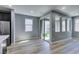 Bright, open-concept living area features wood floors and sliding glass doors to the backyard at 649 Tranquil Jade St, Las Vegas, NV 89138