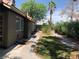 Home's backyard features a small lawn area, rock garden, landscaping, and a sidewalk at 6704 Lost River Ct, Las Vegas, NV 89108