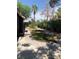 The well-maintained backyard features fresh, green grass and desert landscaping at 6704 Lost River Ct, Las Vegas, NV 89108