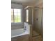 Modern bathroom featuring a soaking tub and a glass-enclosed shower at 6704 Lost River Ct, Las Vegas, NV 89108