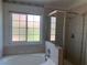 Modern bathroom featuring a soaking tub and a glass-enclosed shower at 6704 Lost River Ct, Las Vegas, NV 89108