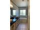 A spacious bathroom featuring dual vessel sinks, granite countertops, tub, and natural lighting at 6704 Lost River Ct, Las Vegas, NV 89108
