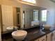 Bathroom with dual vessel sinks, granite countertops, and a tiled shower at 6704 Lost River Ct, Las Vegas, NV 89108