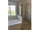 Modern bathroom featuring a soaking tub and a glass-enclosed shower at 6704 Lost River Ct, Las Vegas, NV 89108