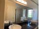 A bathroom with granite countertops, vessel sinks, a large mirror, and tiled shower at 6704 Lost River Ct, Las Vegas, NV 89108