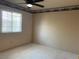 Bedroom with neutral carpet, ceiling fan, and a window allowing natural light at 6704 Lost River Ct, Las Vegas, NV 89108