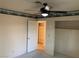 Bedroom featuring a ceiling fan, carpet, closet, and an open door leading to a shelved storage area at 6704 Lost River Ct, Las Vegas, NV 89108