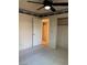 Bedroom featuring a ceiling fan, carpet, closet, and an open door leading to a shelved storage area at 6704 Lost River Ct, Las Vegas, NV 89108