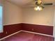 Cozy bedroom with ceiling fan and classic wainscoting detail at 6704 Lost River Ct, Las Vegas, NV 89108