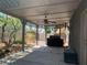 A shaded covered patio features a ceiling fan and leads to a well-kept backyard at 6704 Lost River Ct, Las Vegas, NV 89108
