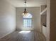 Bright dining area with elegant chandelier and a large arched window at 6704 Lost River Ct, Las Vegas, NV 89108