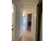 Hallway with wood floors leading to rooms, including a glimpse of a chandelier at 6704 Lost River Ct, Las Vegas, NV 89108