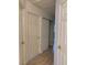 Hallway with laminate wood flooring and doorways into other rooms at 6704 Lost River Ct, Las Vegas, NV 89108