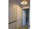 Hallway with white doors and a decorative light fixture at 6704 Lost River Ct, Las Vegas, NV 89108