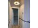 Hallway with a light fixture, white doors, and wood-look flooring at 6704 Lost River Ct, Las Vegas, NV 89108