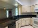 Galley kitchen with granite countertops, tile flooring, and modern appliances at 6704 Lost River Ct, Las Vegas, NV 89108