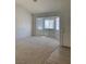 Bright living room features a bay window and neutral carpet and patterned wallpaper at 6704 Lost River Ct, Las Vegas, NV 89108
