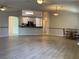 Open concept living room featuring wood flooring and breakfast bar at 6704 Lost River Ct, Las Vegas, NV 89108