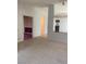 Spacious living room featuring neutral carpet and textured walls for a cozy atmosphere at 6704 Lost River Ct, Las Vegas, NV 89108