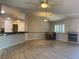 Open concept living room featuring wood flooring, breakfast bar, and dining area at 6704 Lost River Ct, Las Vegas, NV 89108