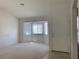 Bright living room features a bay window and neutral carpet and patterned wallpaper at 6704 Lost River Ct, Las Vegas, NV 89108