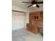 Home office features built-in desk and cabinet storage, carpet, and ceiling fan at 6704 Lost River Ct, Las Vegas, NV 89108