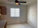 Office space features window with blinds, and carpet flooring, plus built-in cabinets and desk at 6704 Lost River Ct, Las Vegas, NV 89108