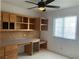Home office space featuring built-in wooden cabinets, drawers, a desk, a window, and carpet at 6704 Lost River Ct, Las Vegas, NV 89108
