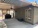 Covered outdoor patio features a ceiling fan and access to the home's interior via double glass doors at 6704 Lost River Ct, Las Vegas, NV 89108