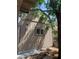 A tan-colored exterior shed is surrounded by trees in the backyard of this residence at 6704 Lost River Ct, Las Vegas, NV 89108