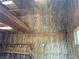 Interior view of shed featuring insulation, wooden beams, lighting, and shelving at 6704 Lost River Ct, Las Vegas, NV 89108