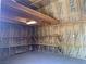 Inside the shed: insulated walls, wooden beams, lighting, and convenient shelving for storage at 6704 Lost River Ct, Las Vegas, NV 89108
