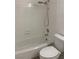 Bright bathroom featuring a shower with white tile surround, toilet, and chrome fixtures at 6704 Lost River Ct, Las Vegas, NV 89108