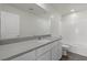 Bright bathroom with quartz countertop, white cabinets, and a shower-over-tub at 6713 Violet Cascade Ave, Las Vegas, NV 89156