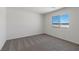 Cozy bedroom features neutral carpet, a window with a view, and ample space at 6713 Violet Cascade Ave, Las Vegas, NV 89156
