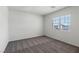 Comfortable bedroom with a large window offering natural light and neighborhood views at 6713 Violet Cascade Ave, Las Vegas, NV 89156