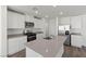 Well-equipped kitchen featuring an island, stainless appliances, and stone countertops at 6713 Violet Cascade Ave, Las Vegas, NV 89156