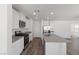 Modern kitchen features stainless steel appliances, gray countertops, and white cabinetry at 6713 Violet Cascade Ave, Las Vegas, NV 89156