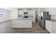 Modern kitchen with a large island, stainless steel appliances, and white cabinetry at 6713 Violet Cascade Ave, Las Vegas, NV 89156